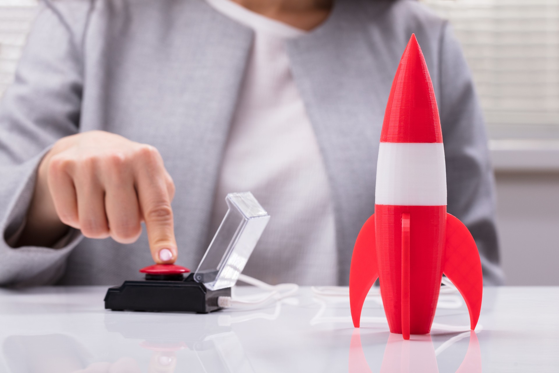 Businesswoman's Hand Launching Rocket