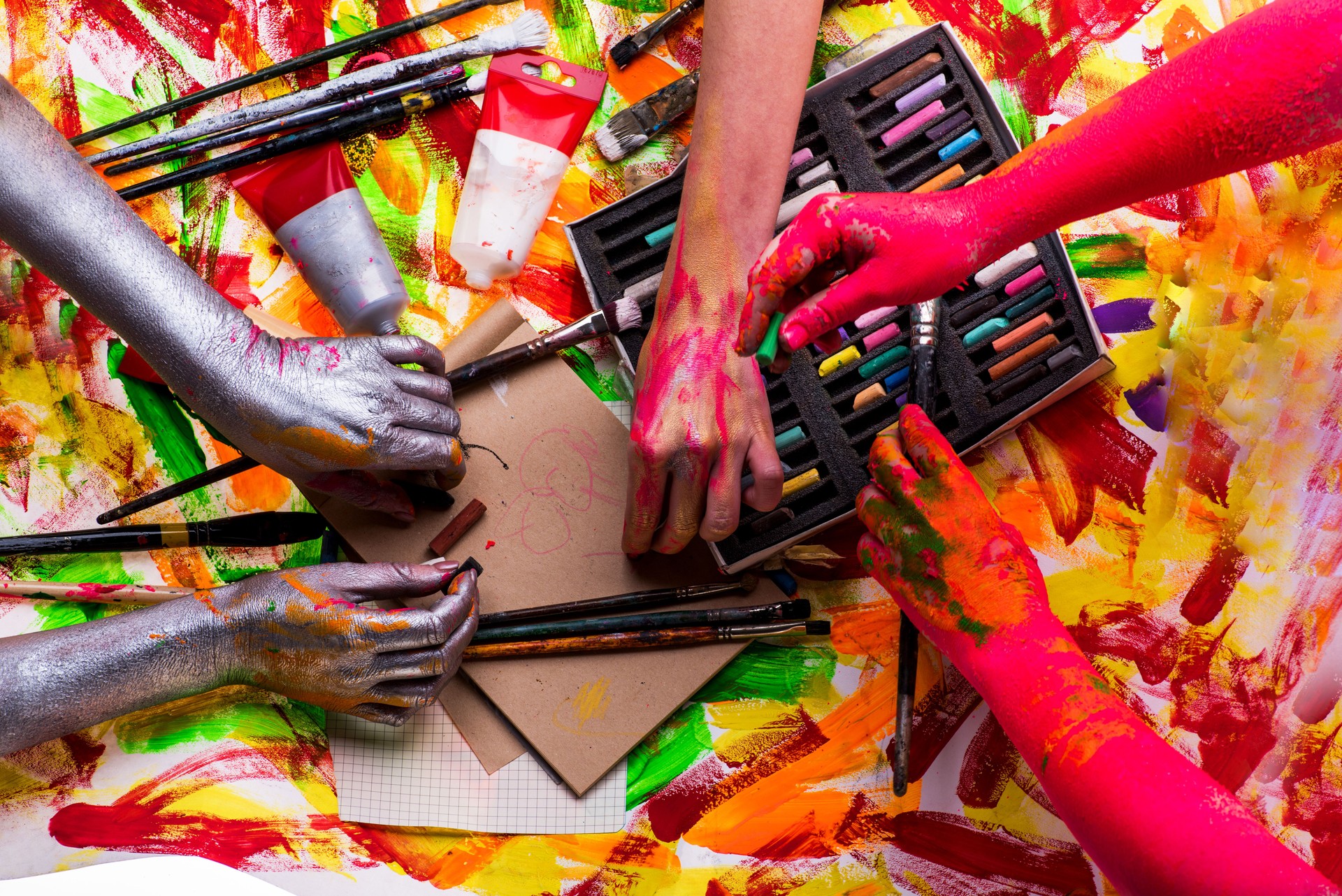 Art therapy, psychology and psychological treatment of mental ailments. Group of people with paints, multi-colored chalk and brushes for drawing at consultation with psychologist. Family leisure